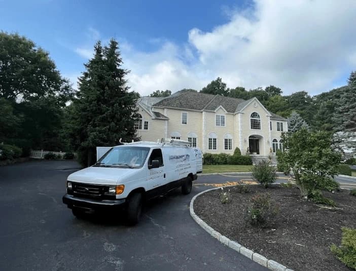 Lakewood Power Washing technician performing thorough gutter cleaning service in Lakewood