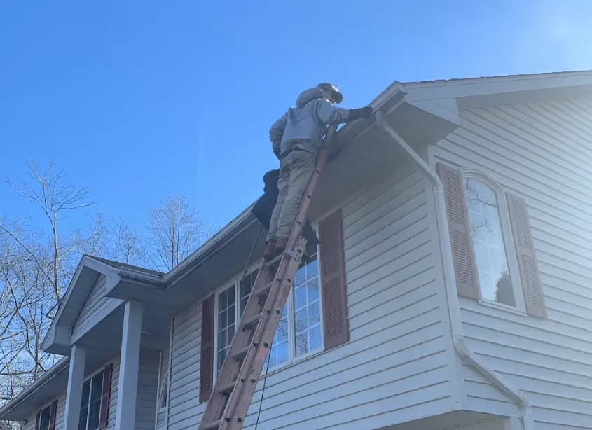 Gutter cleaning and maintenance being performed by Lakewood Power Washing in Lakewood